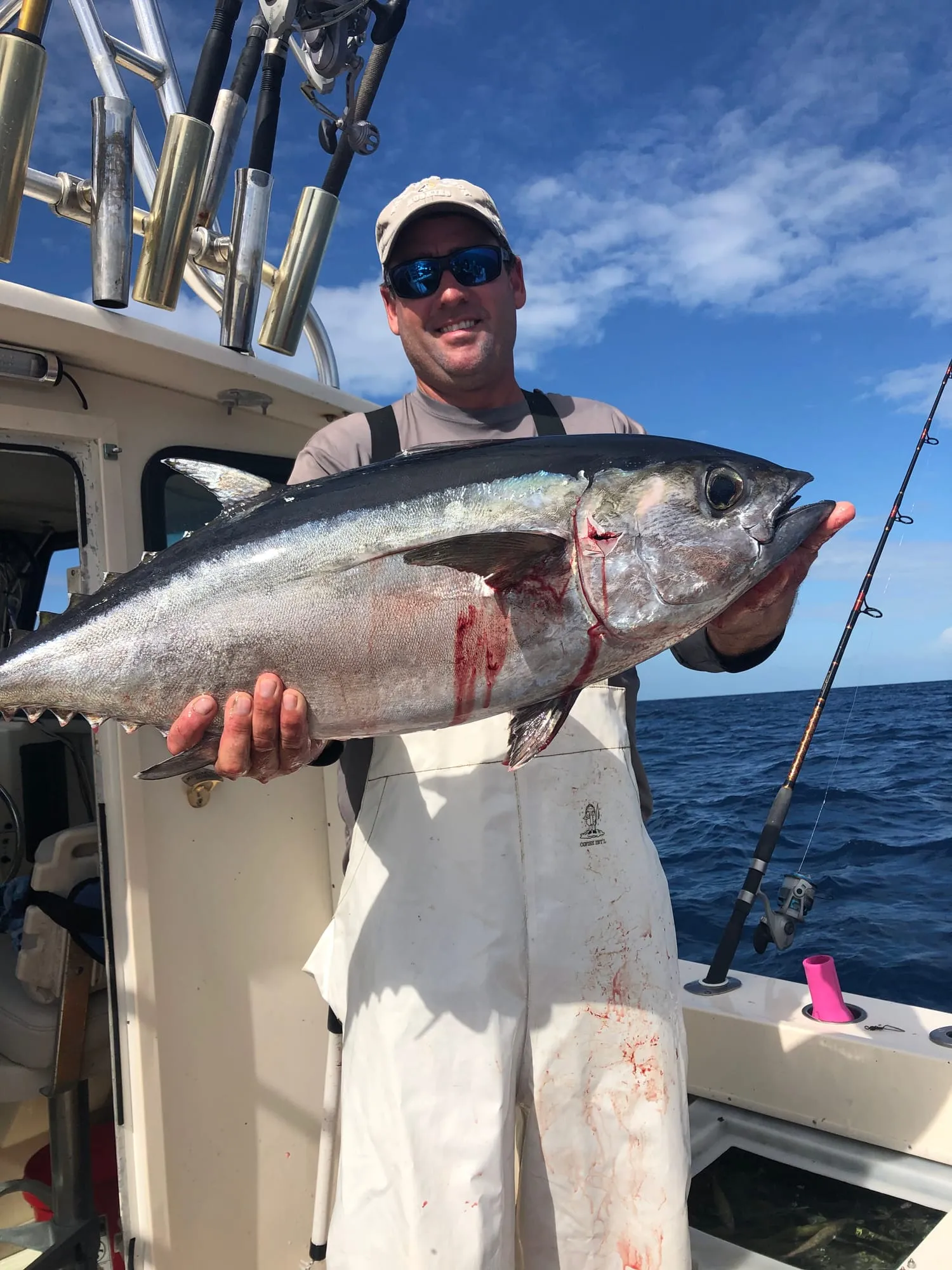 Captain Brian holding a big tuna aboard Satisfaction